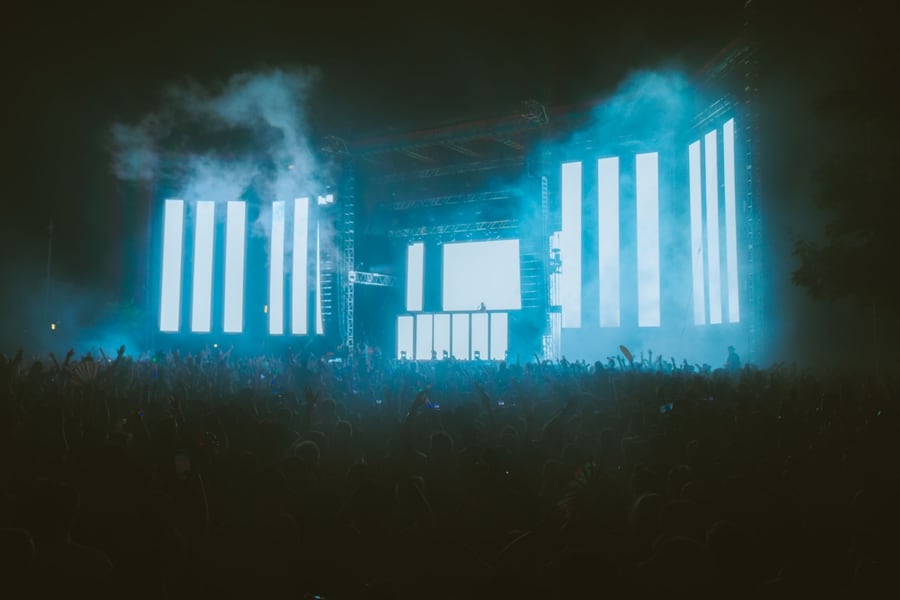 Vertical LED columns glowing through cyan haze