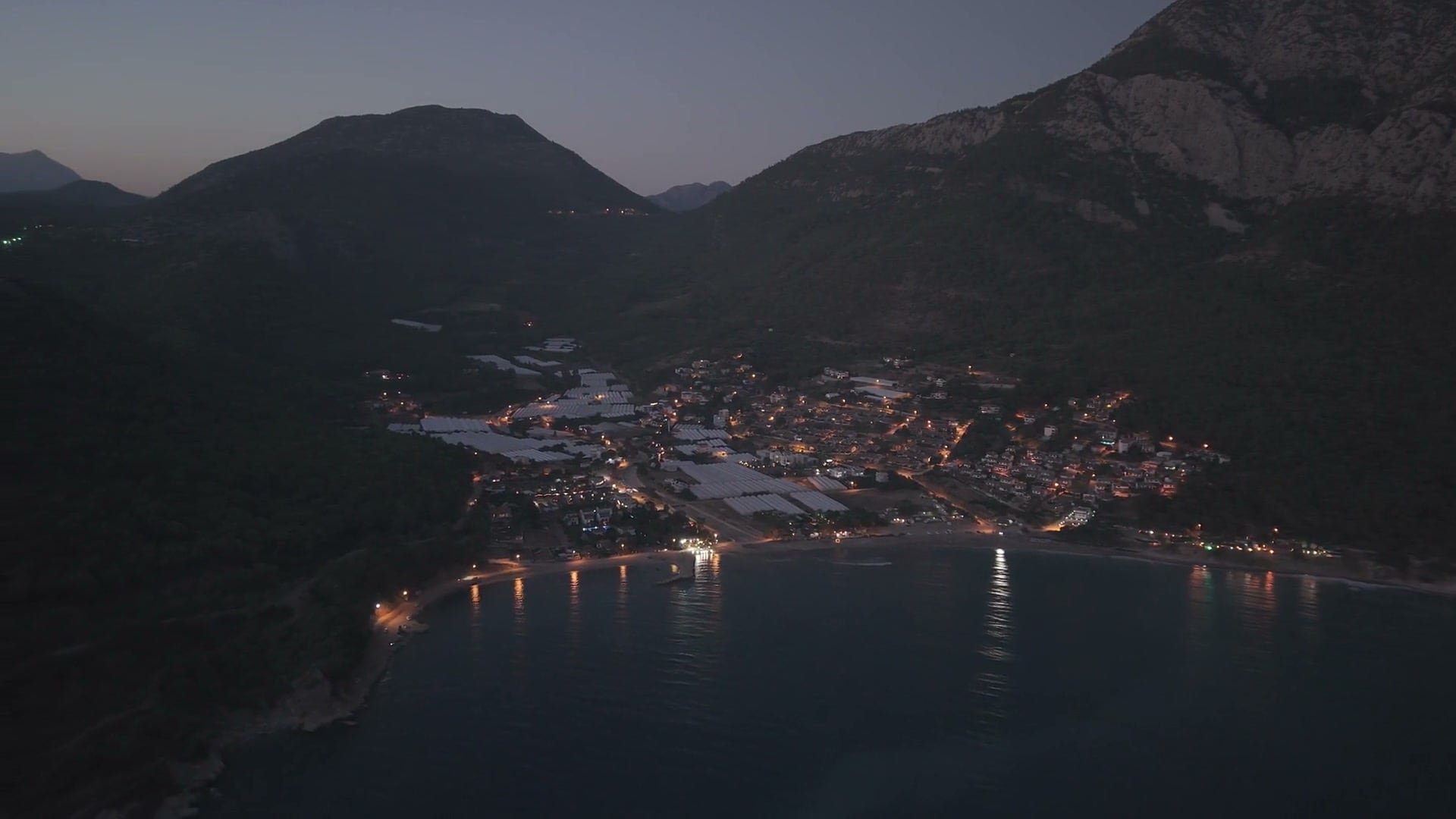 Aerial over a coastal town at dusk